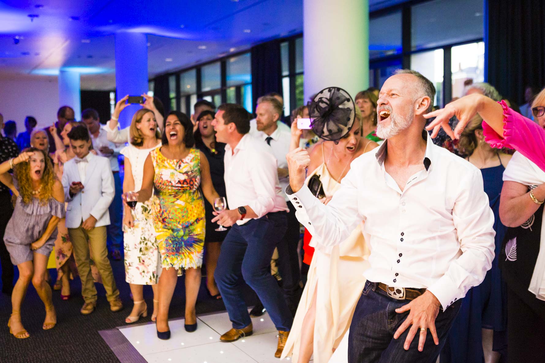 Guest make some shapes on the dance floor at an Essex Wedding