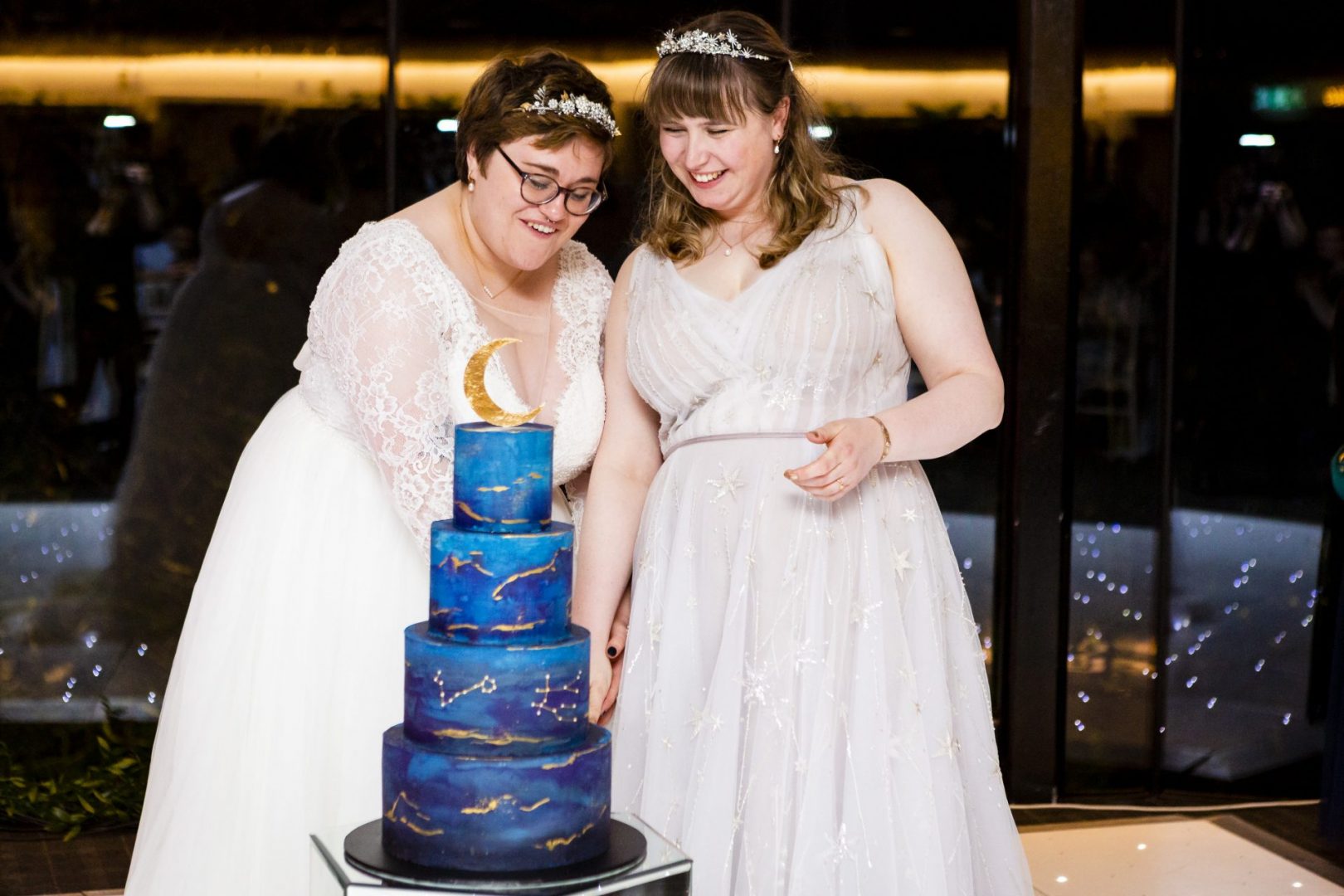 Two brides cut their wedding cake
