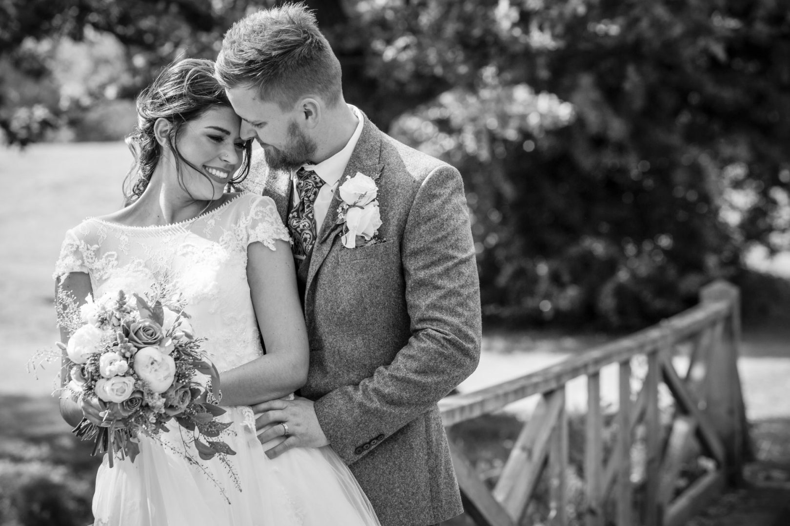 Essex Wedding Photographer - a black and white image of a bride and groom hugging