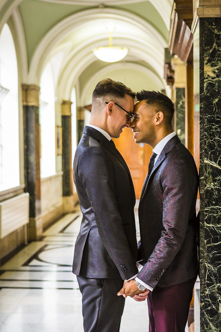 Grooms with their foreheads touching at islington town hall