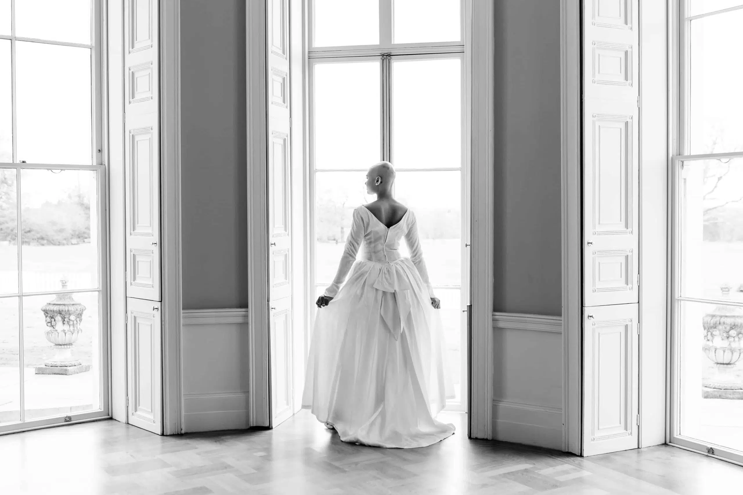 A bride looking out of the window at Hylands House