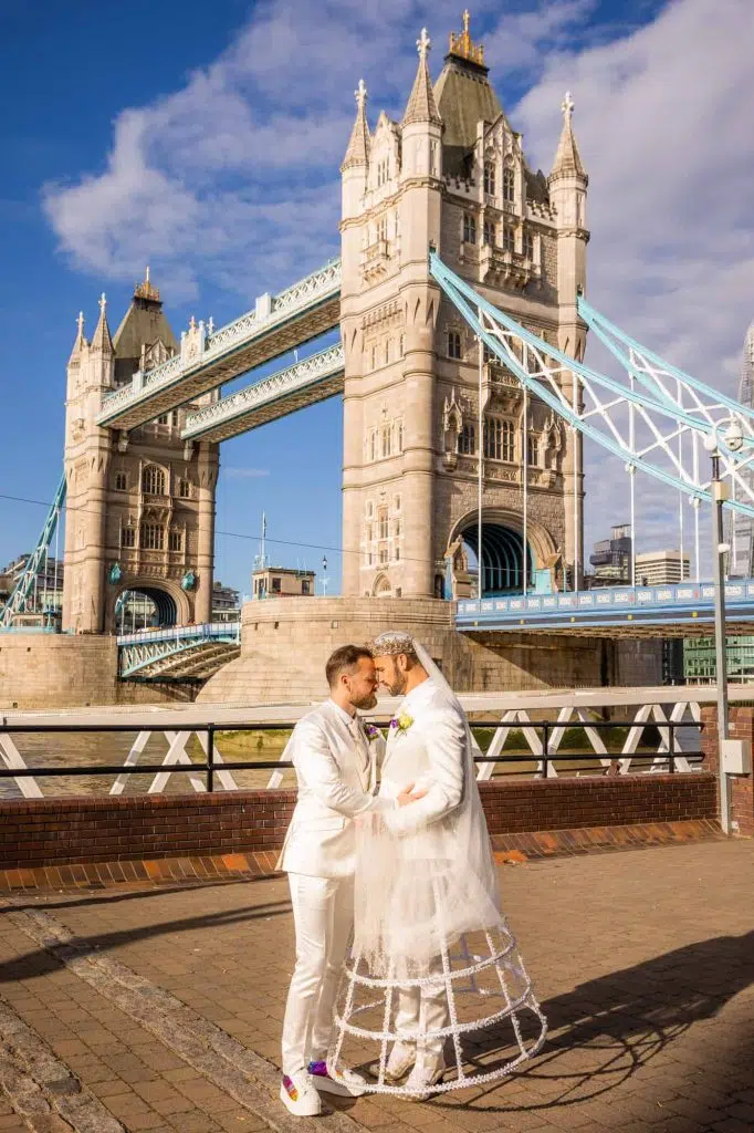 London elopement photographer = two grooms kissing in front of Tower Bridge