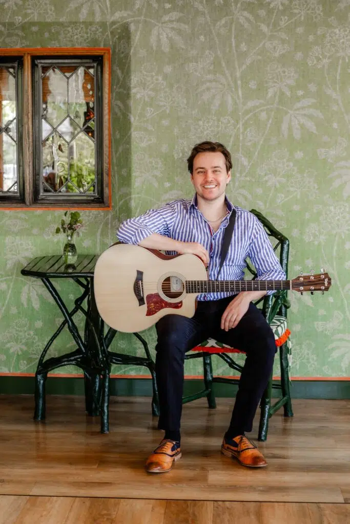 Joe Bailey sat wit hhis guitar