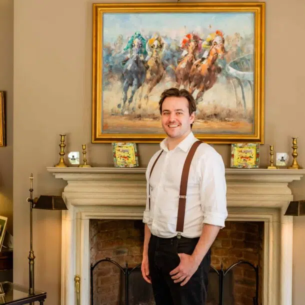 Joe Bailey photographed by the fireplace at Old Hall Ely