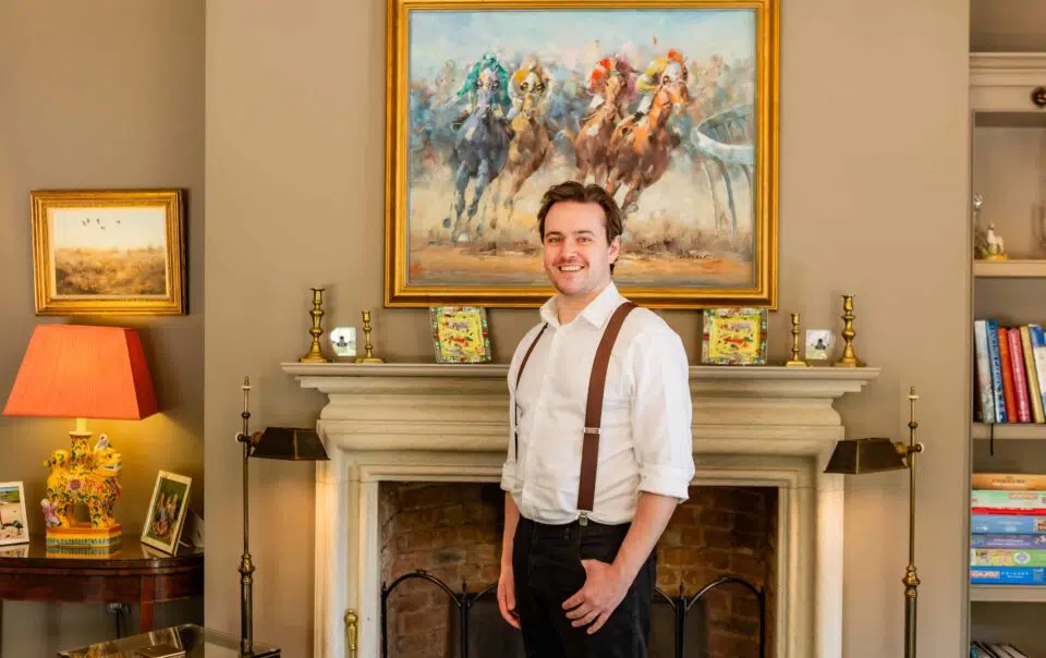 Joe Bailey photographed by the fireplace at Old Hall Ely