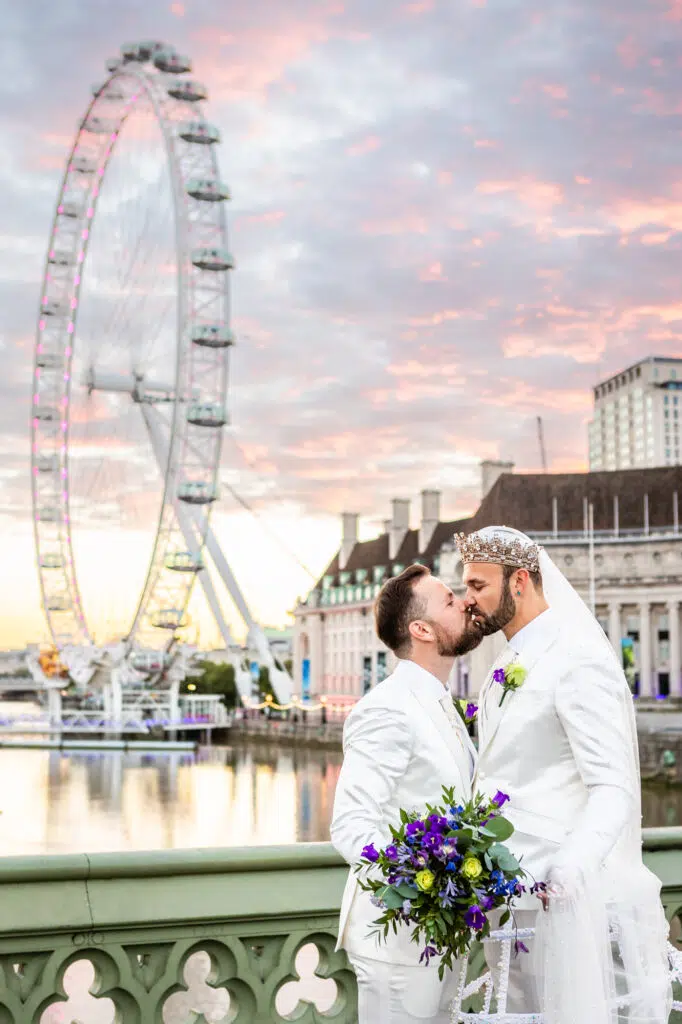 Tow grooms kissing in front of the London Eye captured by a LGBTQ wedding photographer London