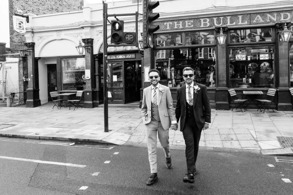 Two grooms crossing the road in Kentish Town