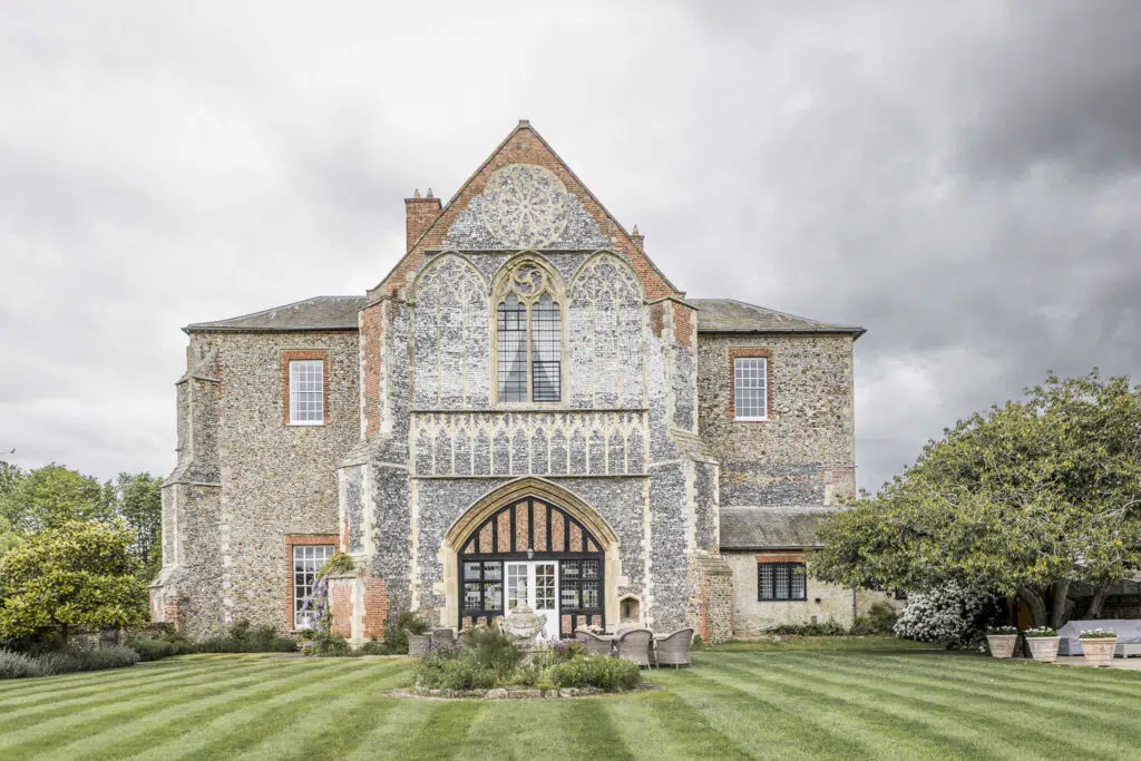 the rear view of butler priory wedding venue and lawn.