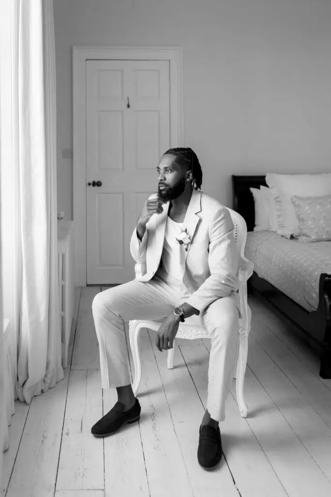 black and white groom portrait in the bedroom of butler priory Suffolk