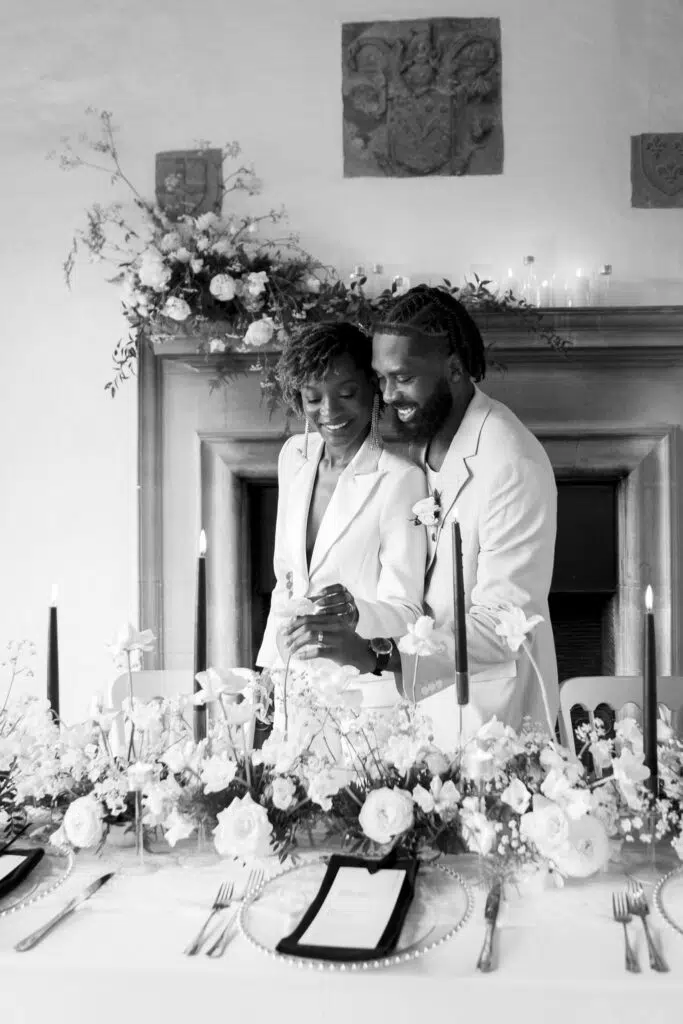 a couple looking at their wedding breakfast table at Butley Priory Suffolk