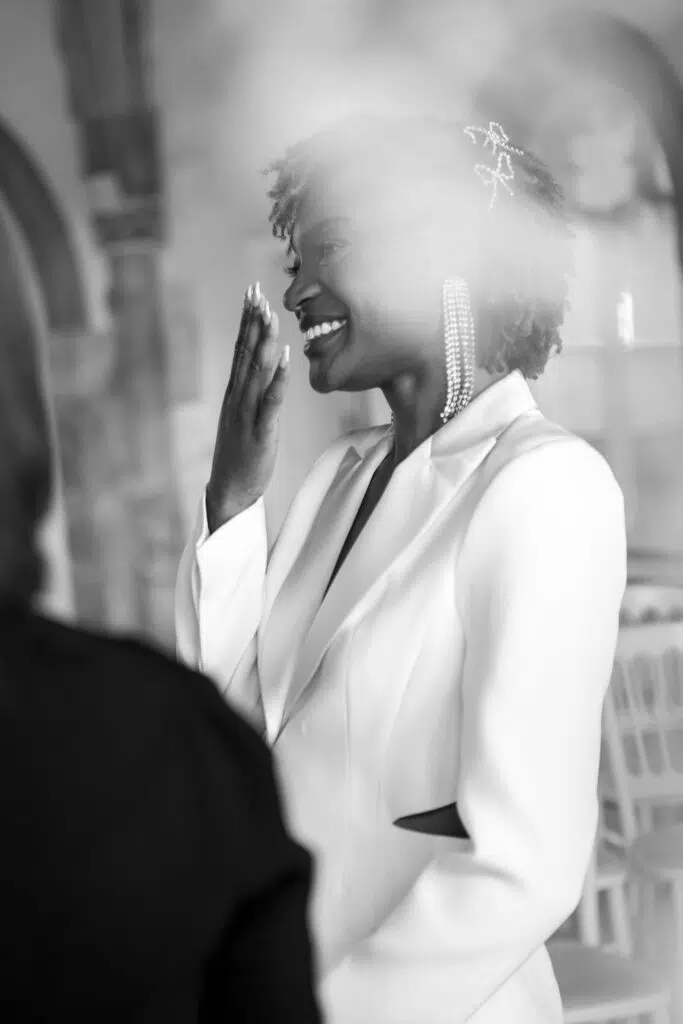 a bride giggling during her wedding ceremony at Butley Priory.