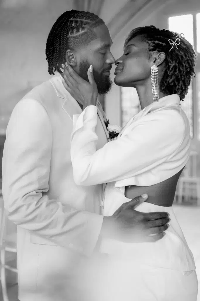 A bride and groom about ot kiss during their wedding ceremony at butler priory Suffolk