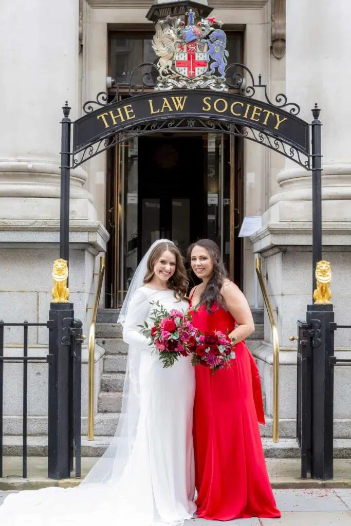 A bride and bridesmaid posing for a photo outside The Law Society