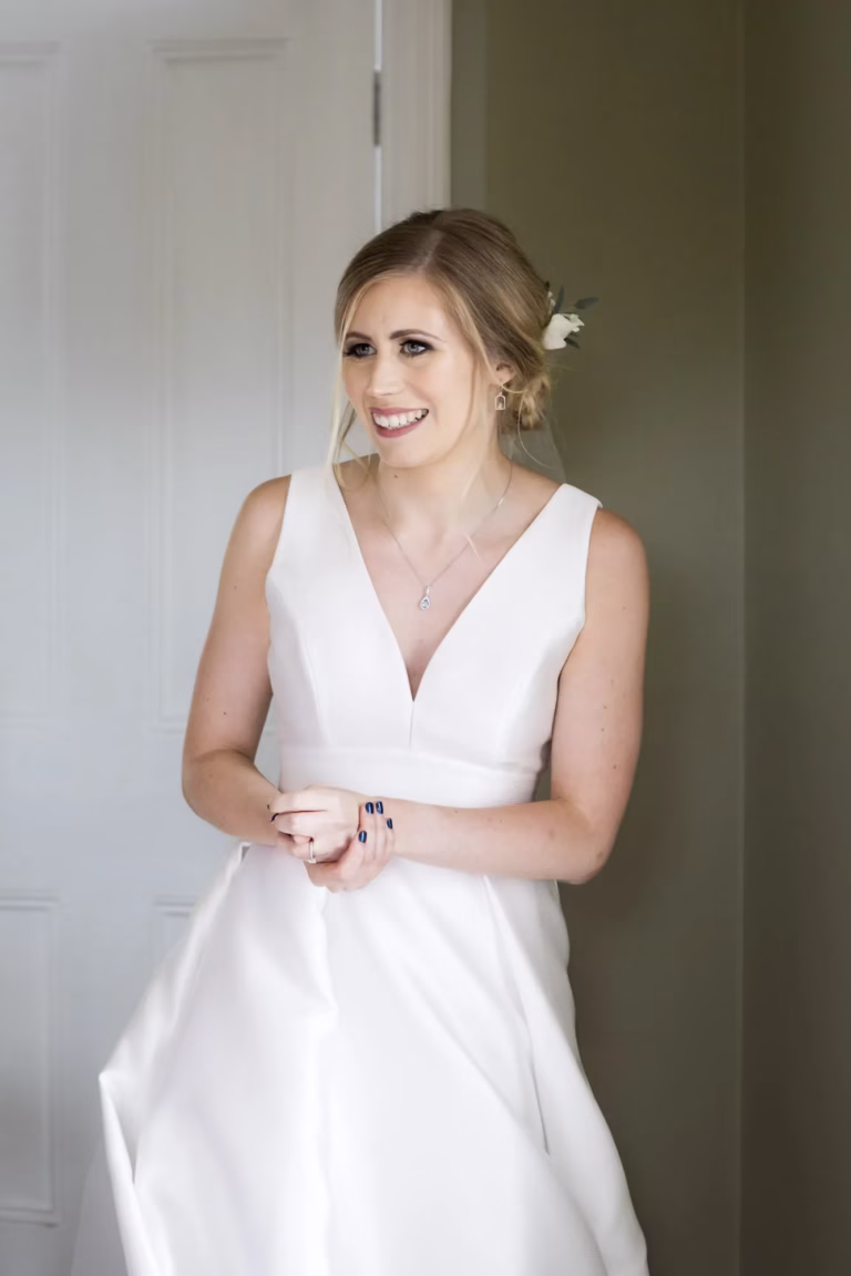 A bride smiling on the morning of her wedding