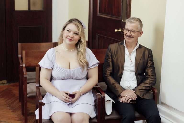 Guests smiling as Pete and Will exchange vows.